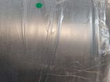 a large metal barrel wrapped in plastic on a table