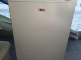 an image of a small white refrigerator in a room