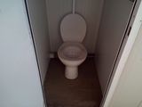 a toilet that is in the corner of a room