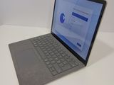 a laptop that is sitting on a table with a keyboard