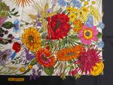 a picture of a colorful floral print scarf on a black background