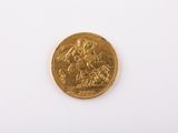an image of a gold coin sitting on top of a white surface