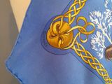 a blue scarf with a picture of a bear and a tree on it