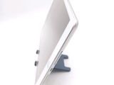 a tablet computer sitting on a stand on a white surface