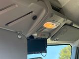 a television mounted to the ceiling of a vehicle