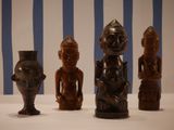 three wooden figurines sitting on a table next to each other