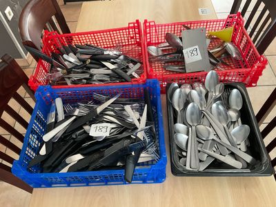 two baskets of silverware sitting on a table