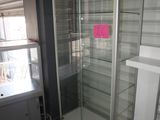 a glass display case in the corner of a room