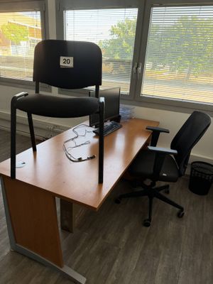 a desk with a chair and a computer on it