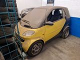 a small yellow and black car parked in a garage