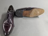 pair of men ' s shoes on a table with a white background