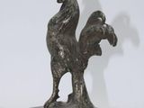 statue of a rooster on a marble base on a white background