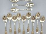 six spoons and six spoons sitting on a table