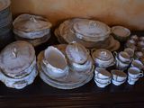 a lot of dishes and cups on a table
