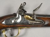 a close up of a gun on a table with a white background