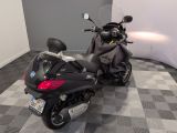 a motorcycle that is parked in a room with a checkered floor