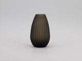 a black vase sitting on top of a white table