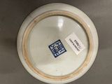 a white bowl with a blue sticker on it