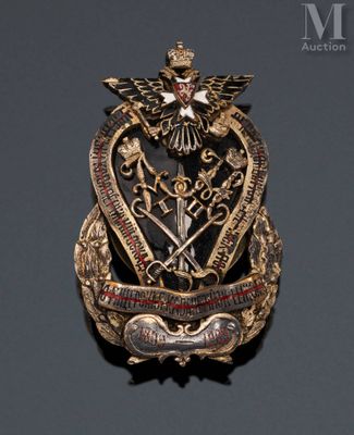 an image of a gold and red broochle with a bird on it