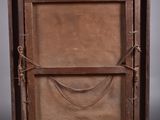 an old wooden easel with a painting on top of it