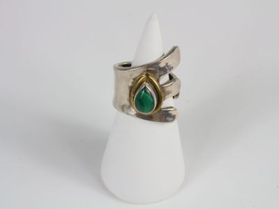silver and gold ring with a green tear