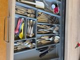 a drawer full of utensils and spoons in a kitchen