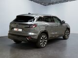 the rear end of a silver suv parked in a garage