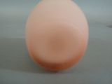 an egg sitting on a table with a white background
