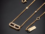 three gold necklaces with diamonds on a black background