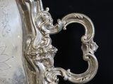 a silver plate with a picture of a woman on it
