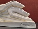 a white sculpture of a dog on top of a table