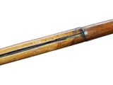 an old rifle with a wooden handle on a white background