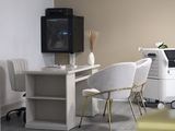 a room with a desk, chairs, and a tv in it