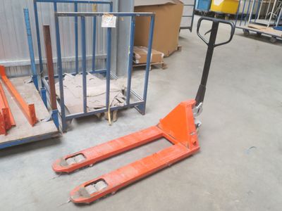 a fork lifter sitting in front of a pallet in a warehouse