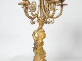 brass candelabra with a woman holding a candelabra on a stand