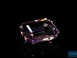 a pink diamond on a black surface