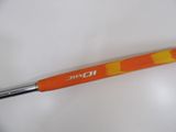 an orange and yellow handled tool on a white surface