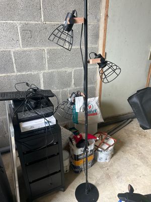an image of a room with a desk, chair, and lamp