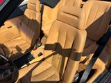 the interior of a car with tan leather seats and a black steering wheel