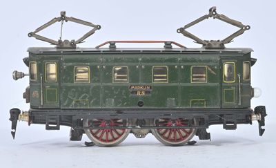 a green train on the tracks on a white background