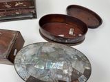 three wooden boxes and one has a mother of pearl in it