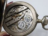 a close up of a pocket watch being held by a person