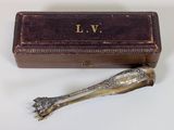 a silver spoon sitting next to a box on a table