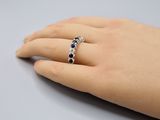 a close up of a person ' s hand with a ring on it