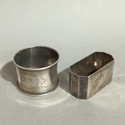 a silver cup and a silver container on a white surface