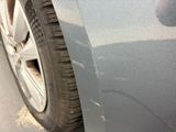 a close up of a car ' s front bumper with scratches on it