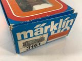 the box of a toy train is sitting on a white surface