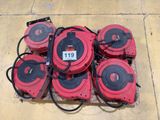 several red and black blowers sitting on top of a cement floor