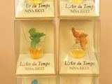 six glass figurines of different birds in a display case