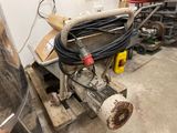 a machine that is sitting on a pallet in a garage